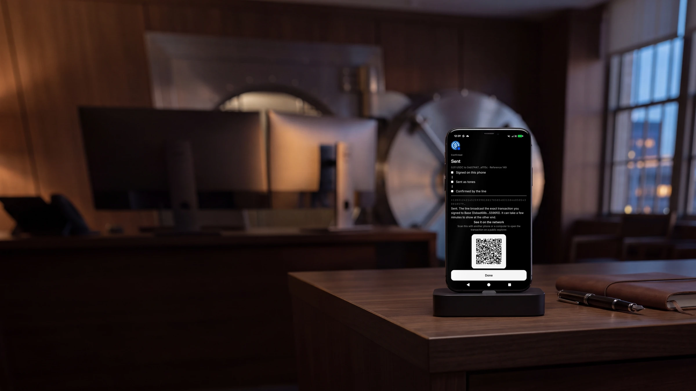 A dedicated broadcast handset standing upright in a dock on a walnut desk in a treasury room at dusk, a vault door behind it, its screen showing the TELRPC Wallet confirming a sent payment