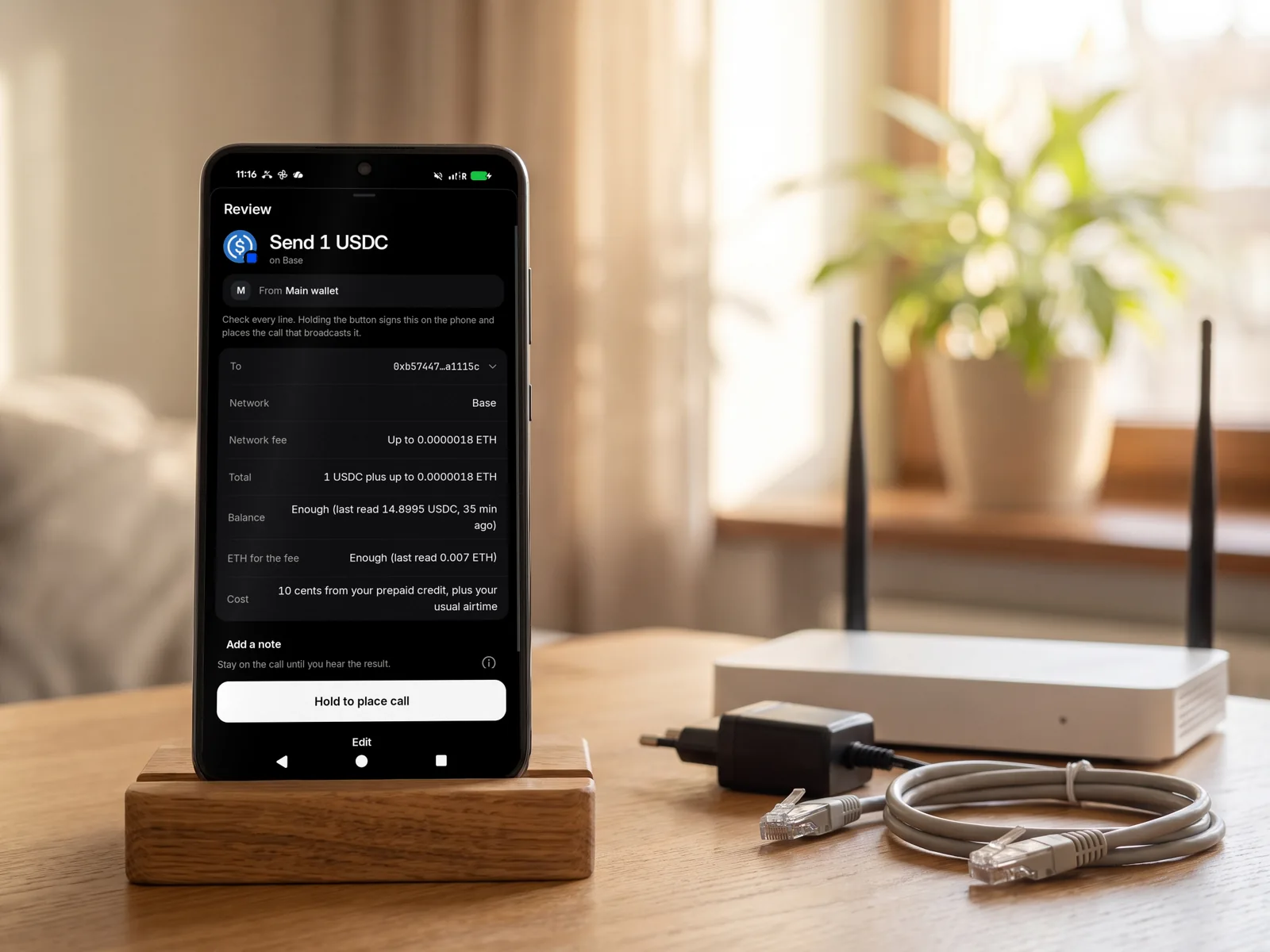 A phone showing a TELRPC payment, the Review screen for sending 1 USDC on Base, beside an unplugged Wi-Fi router with its power and network cables lying loose